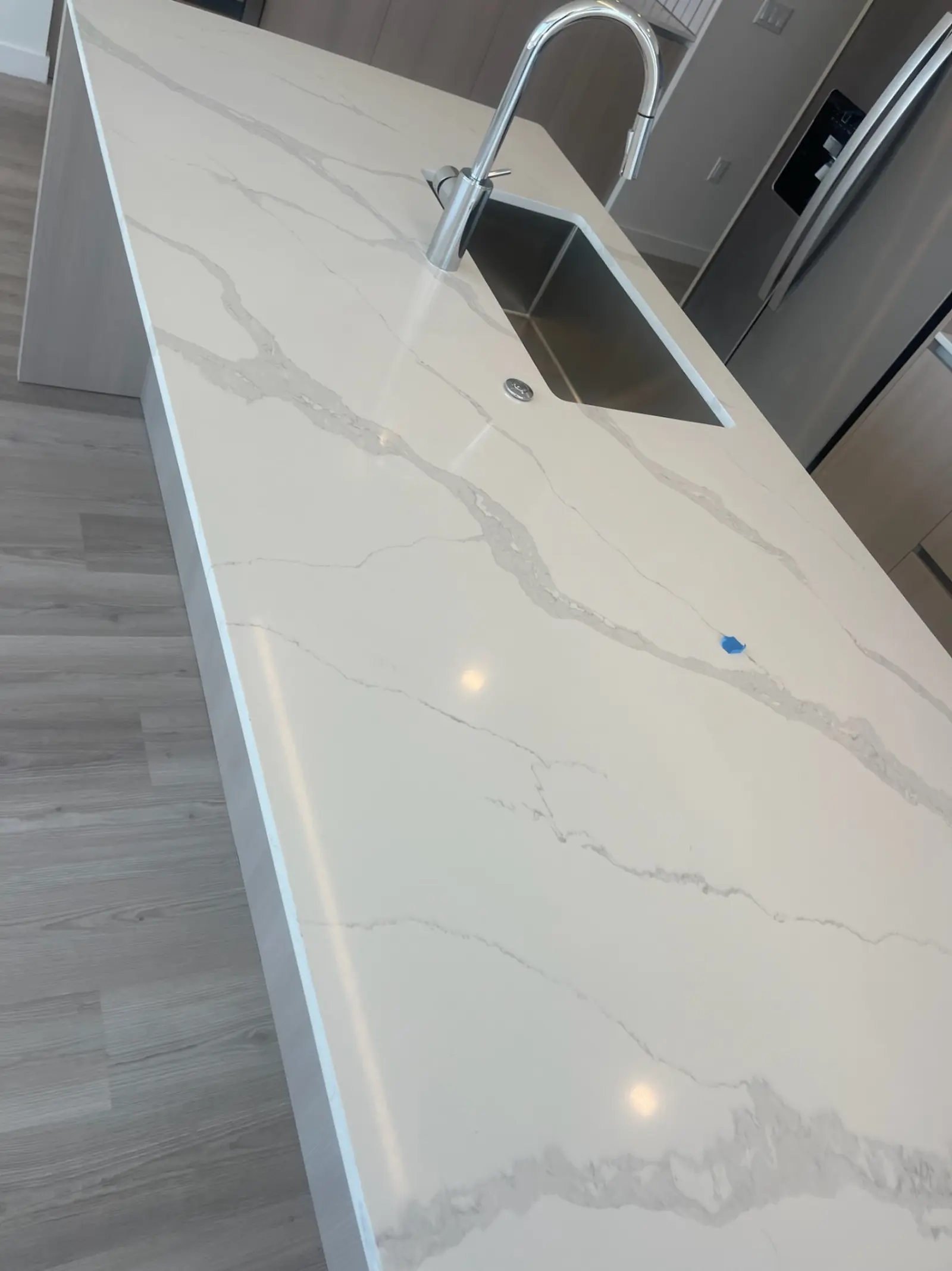 New construction kitchen cleaning San Antonio TX - quartz countertop island and sink for luxury apartments